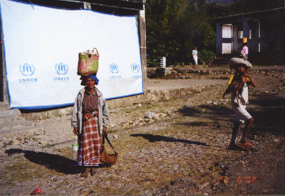 14 woman with basket on head Ainaro