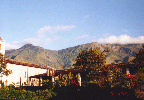 6 catholic church Ainaro, wrecked schoolbuilding, mountains